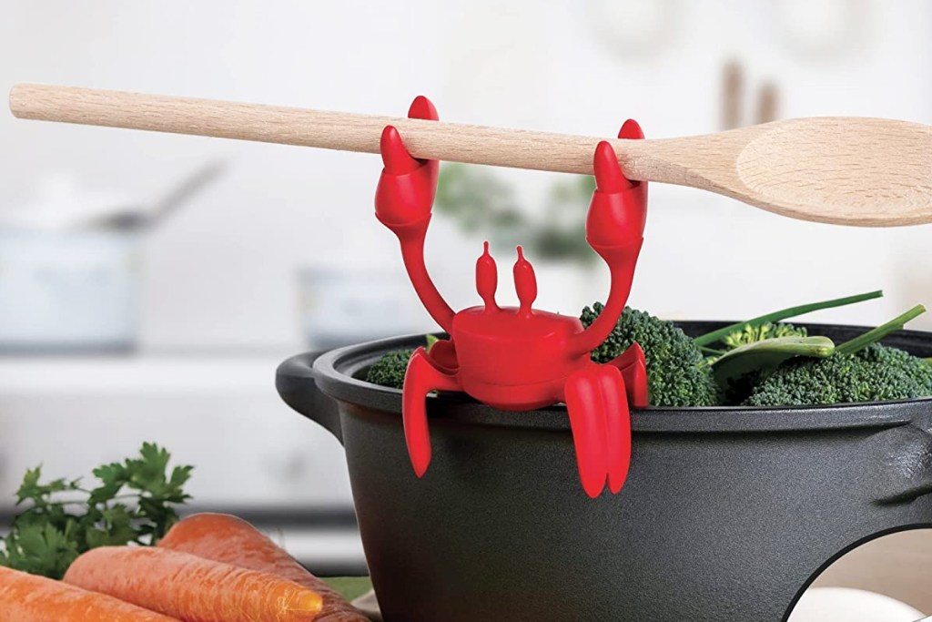 red crab holding wooden spoon