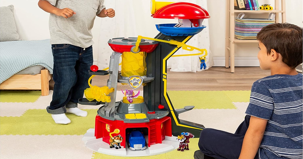 Paw Patrol Lookout tower on the floor with two boys playing on either side.