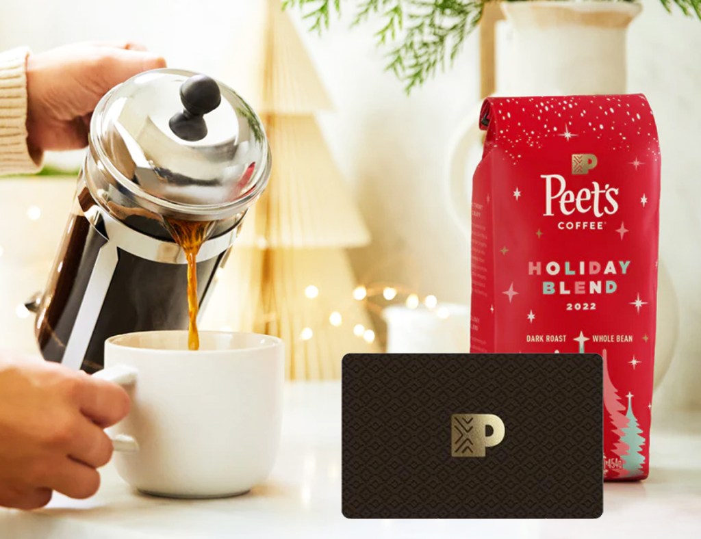 pouring cup of coffee near coffee bag and gift card