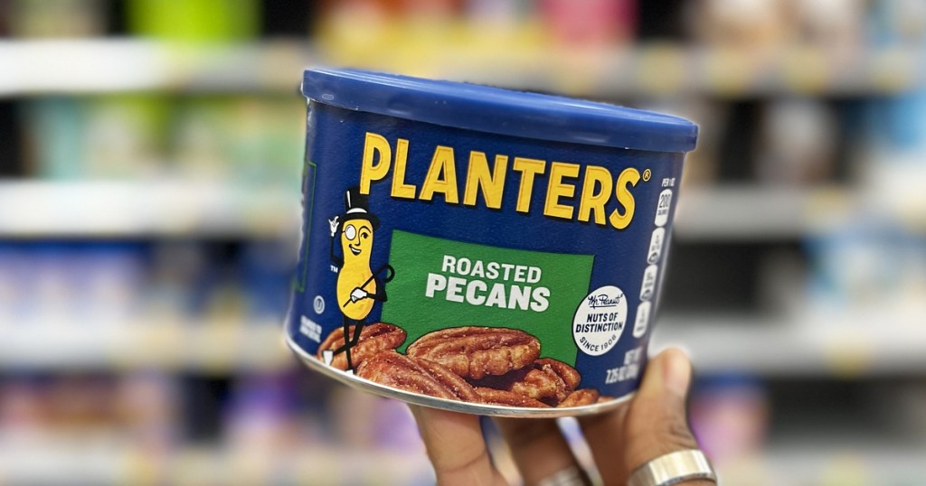 hand holding up container of Planters Roasted Pecans