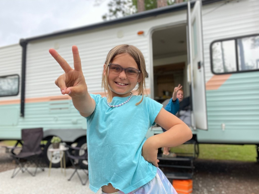 Girl playing outside an RV rental from RVshare