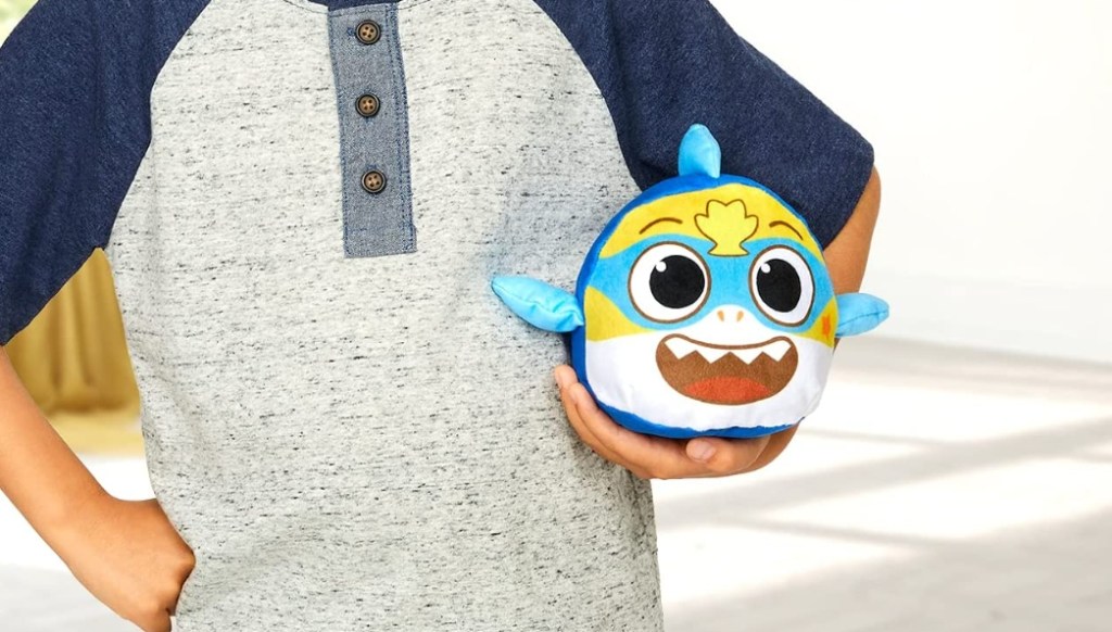 boy holding a Reversible Plush Baby Shark