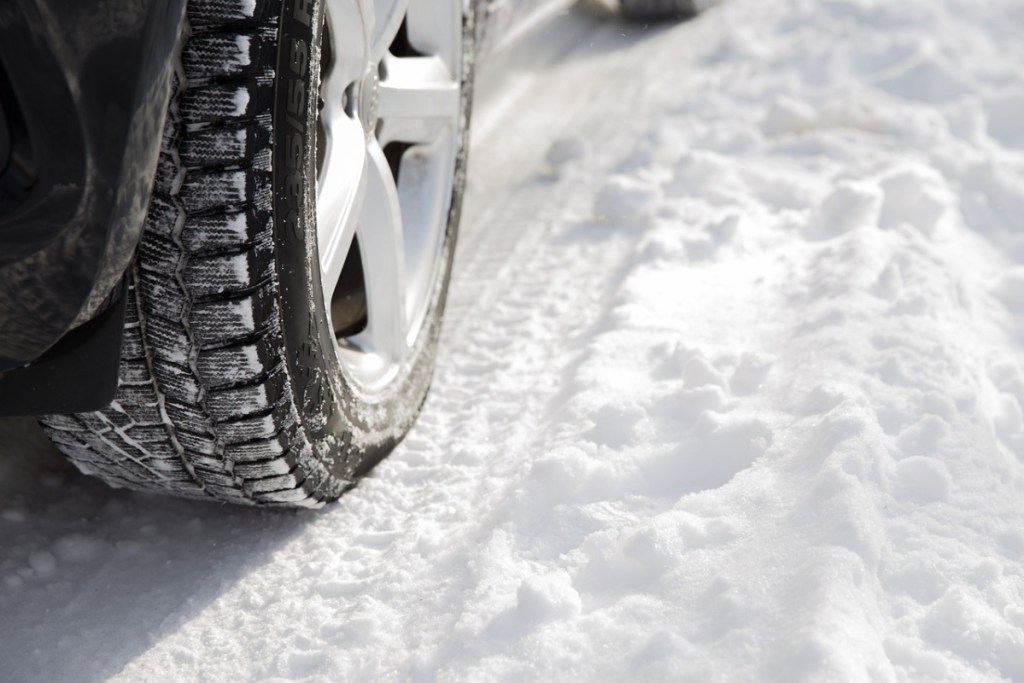 Snow Tires - car driving through snow - save on tires