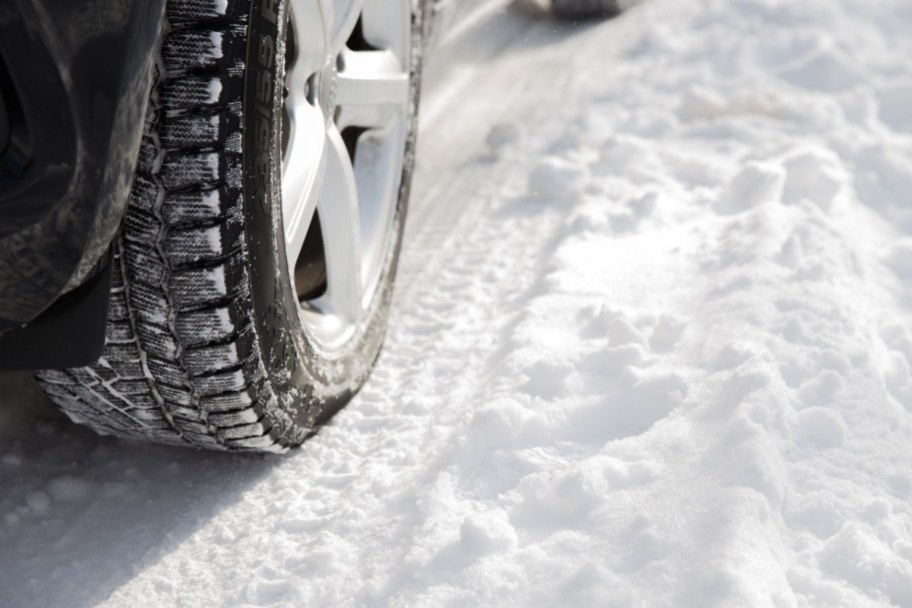 Snow Tires - car driving through snow - save on tires