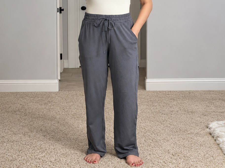 woman wearing white top and grey sweatpants
