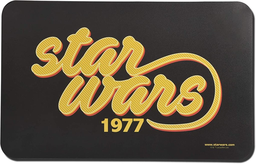 Black dog mat that says Star Wars 1977 in gold