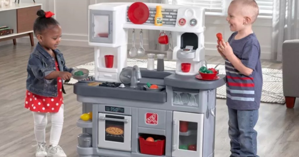 two children playing in front of gray kitchen