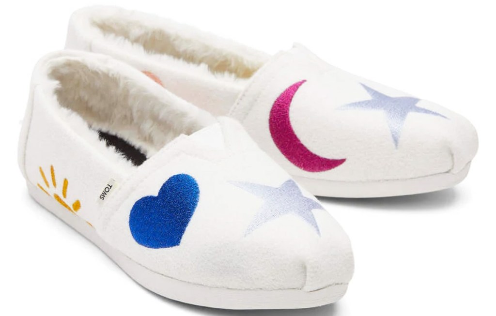 white pair of embroidered shoes