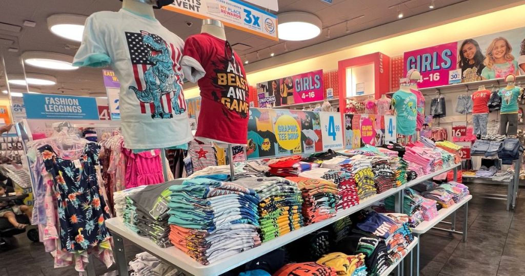 store display at The Children's Place with tons of folded graphic tees for kids