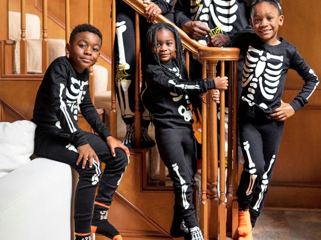 A family wearing The Children's Place Halloween Pajamas Skeleton