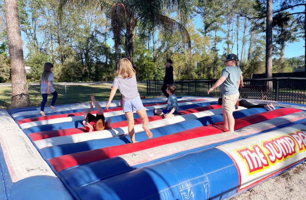 Kids playing on a jump pad at the KOA North Jacksonville campground