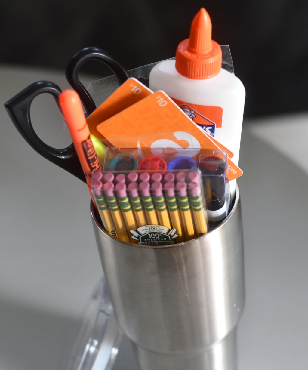 A tumbler filled with school supplies which is one of our favorite diy teacher gifts
