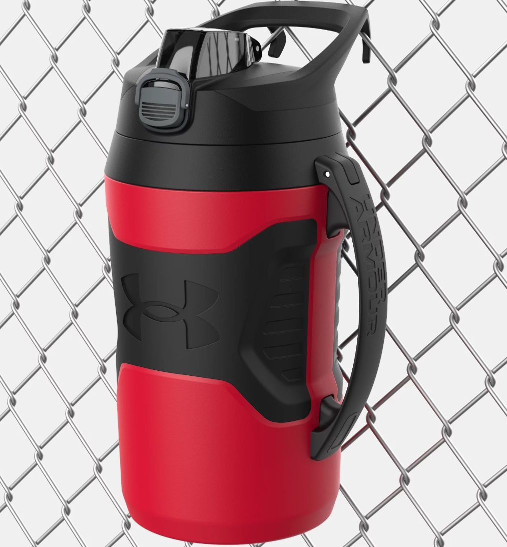 Red and black Under Armour water jug hanging on a fence