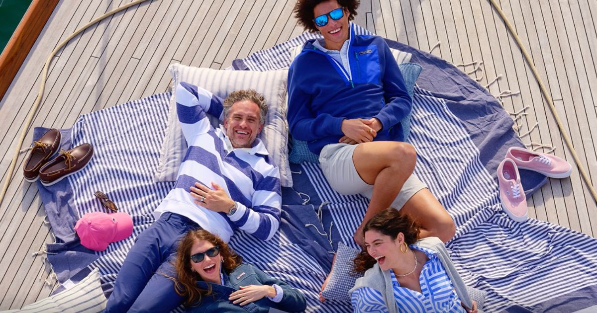 People on the deck of a boat relaxing and wearing clothes from VIneyard VInes