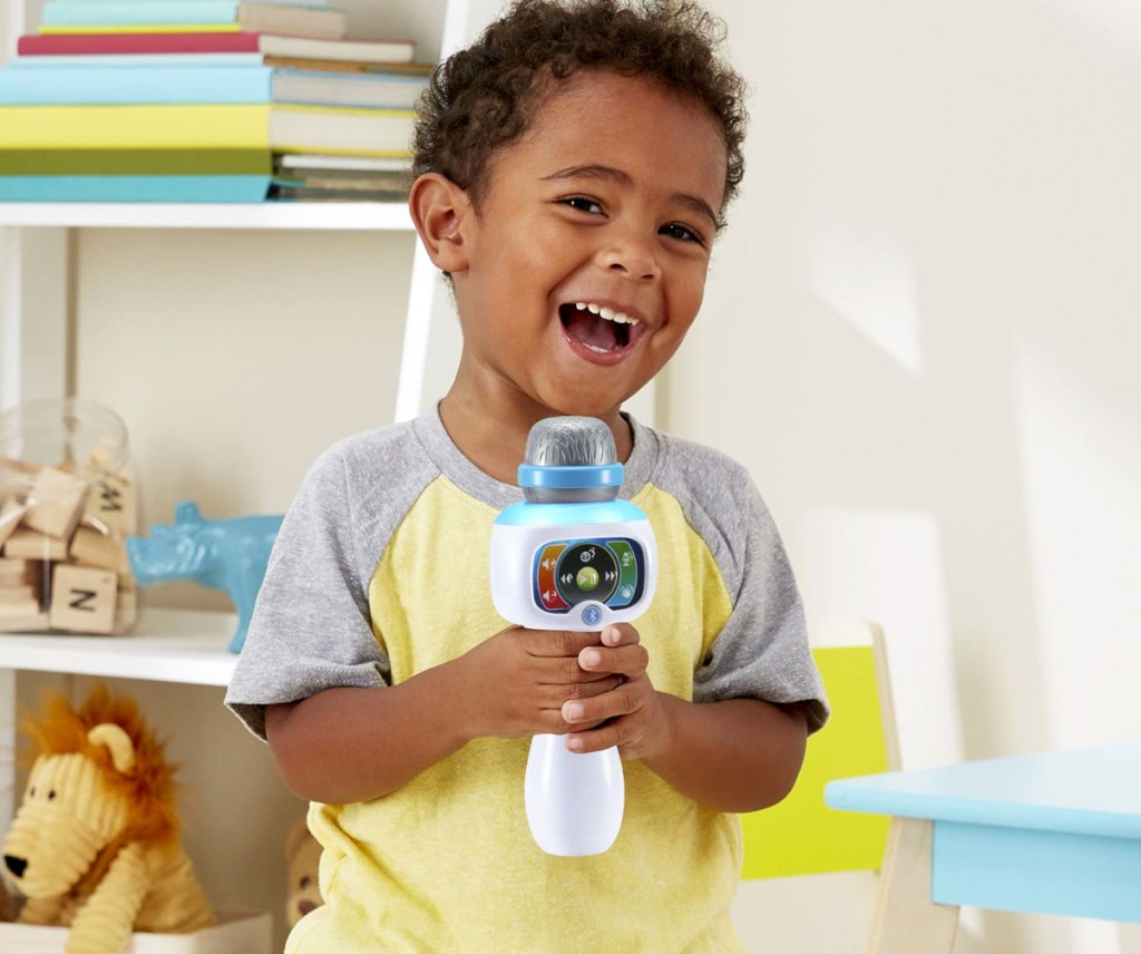 boy holding vtech microphone