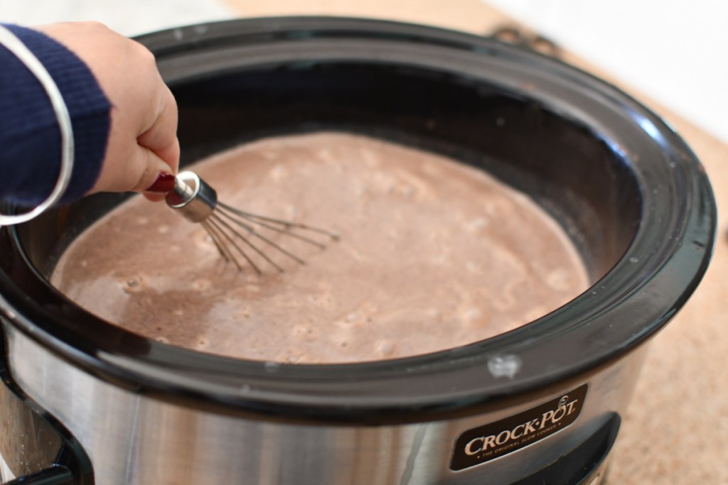 Whisking hot cocoa in a slow cooker or Crock Pot