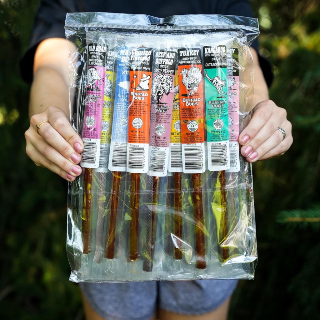 Person holding up a set of Wild Game Snack Meat Sticks which make great christmas gift ideas for men