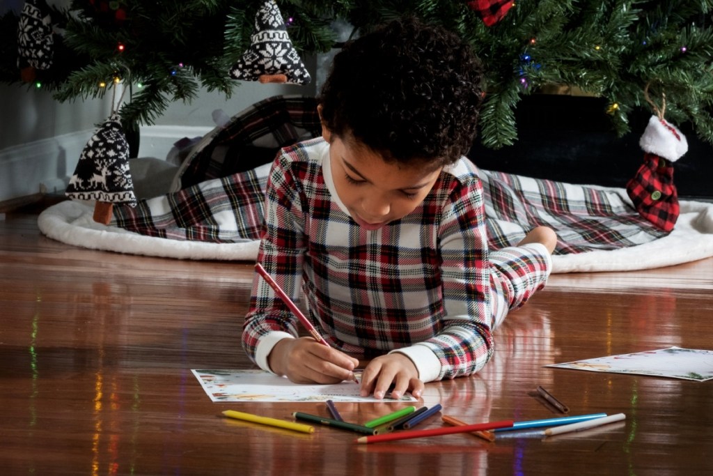 Boy writing a letter to Santa Clause 