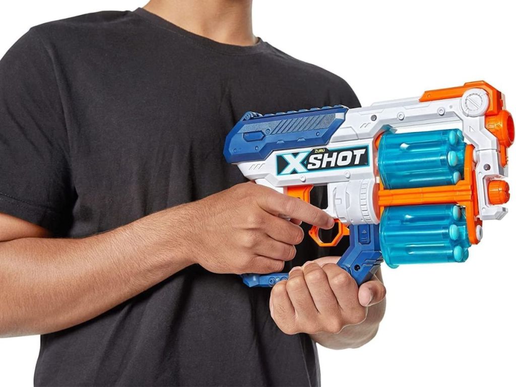 A man holding a nerf-like gun
