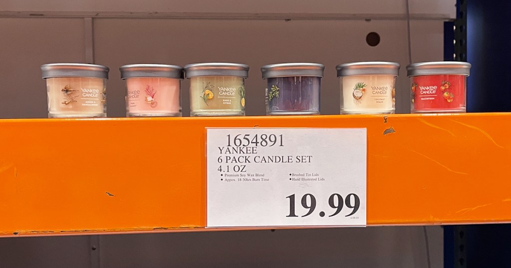 6 small yankee candles on orange shelf at costco