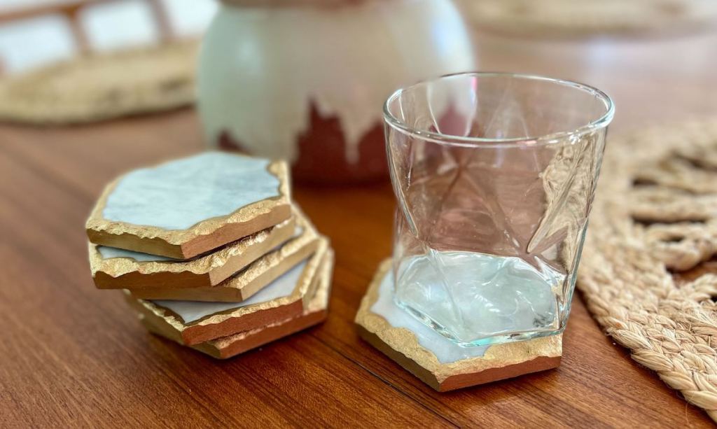 marble coasters on wood table with clear glass cup