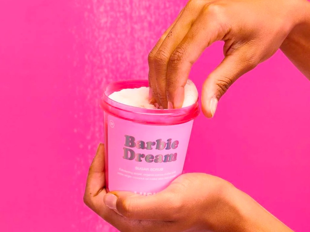 hand scooping barbie dream lotion out of container