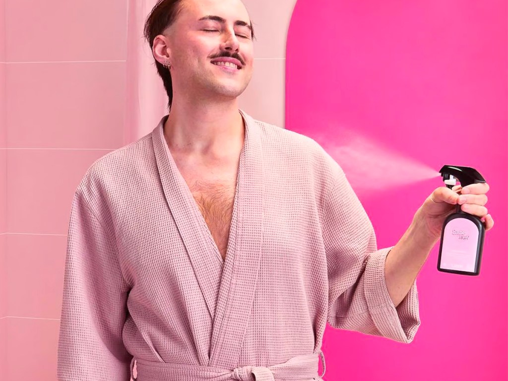 man spraying barbie lush spray