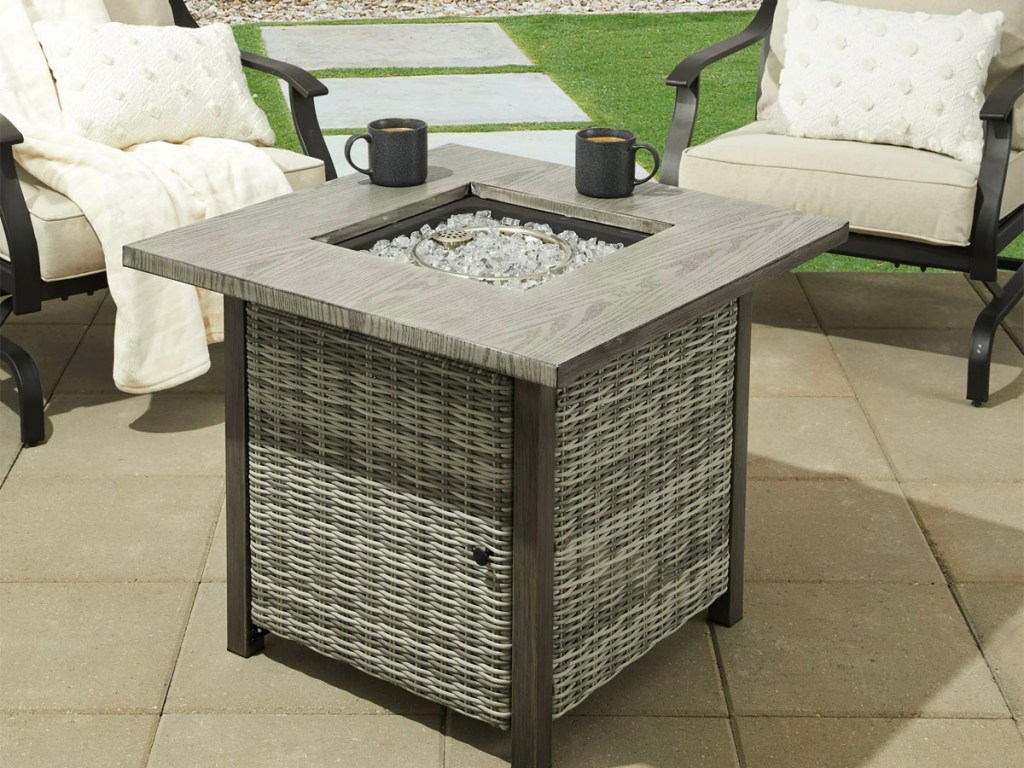 gray fire pit square table in the middle of patio furntiure