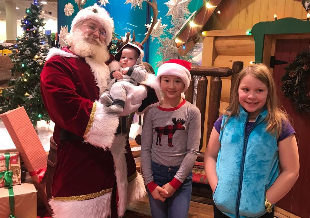 kids standing with santa in cabelas store