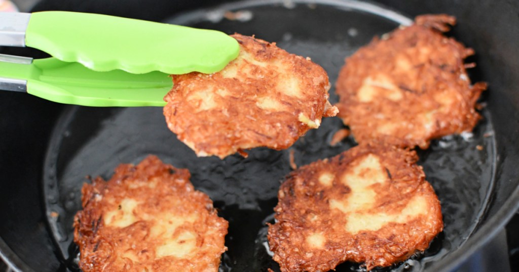 cast iron pan with finished potato latkes