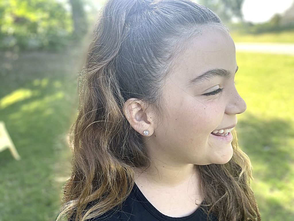 girl wearing stud earrings