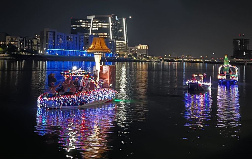boat parade on water with christmas lights and leg lamp