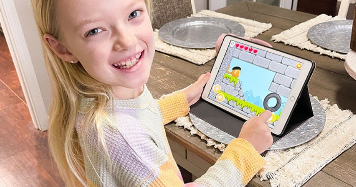 little girl with tablet playing codespark