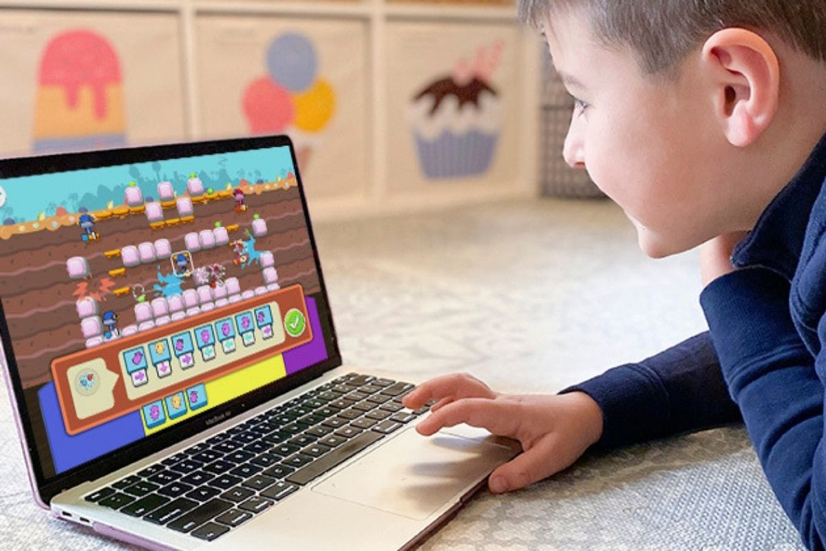 little boy on a laptop playing codespark coding game