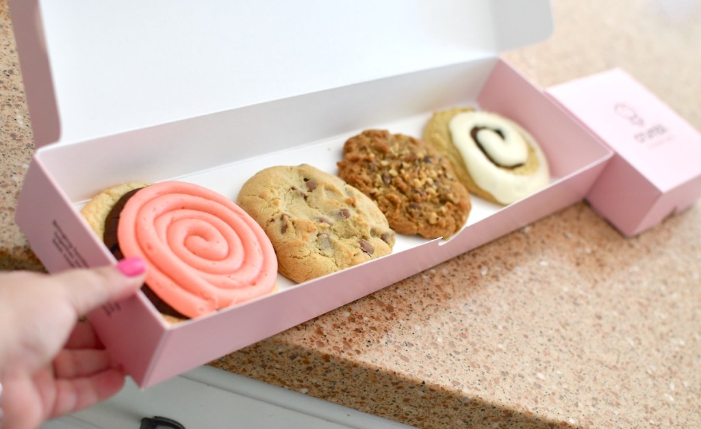 row of crumbl cookies in pink box