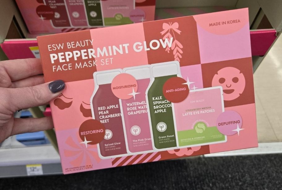 a womans hand holding an skin care gift set