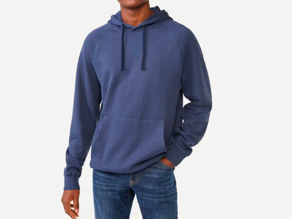 man wearing blue hoodie and jeans
