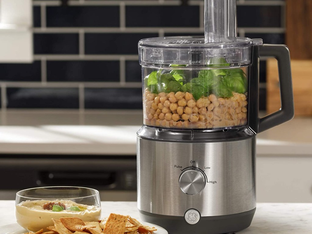 ge small appliance food processor filled with chickpeas and basil