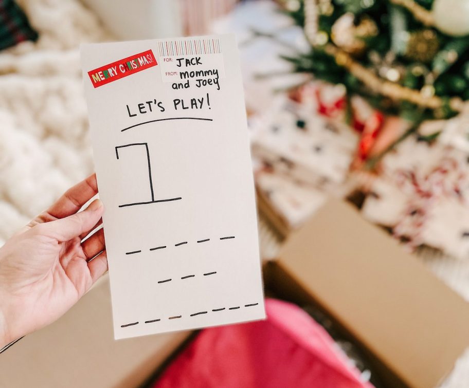 hand holding a gift wrap hangman game idea