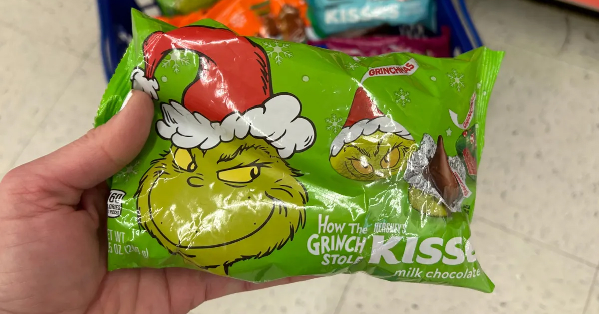 hand holding green bag of grinch hersheys kisses