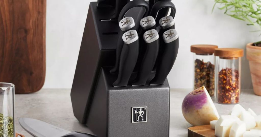 Henckels 14 piece knife block set on a kitchen countertop where someone was chopping vegetables