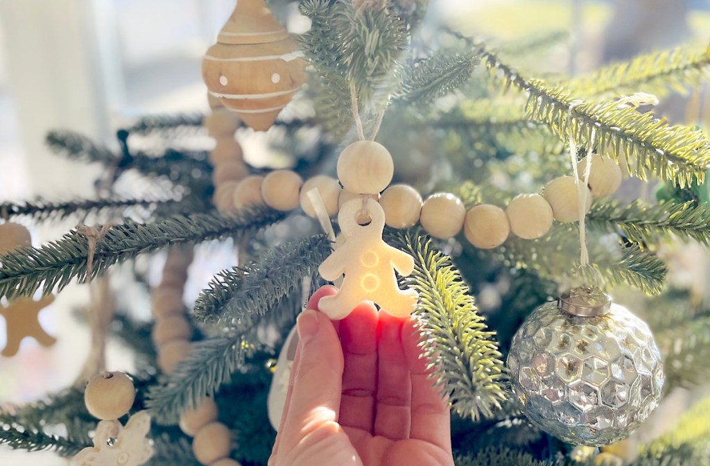 hand holding salt dough ornament on tree