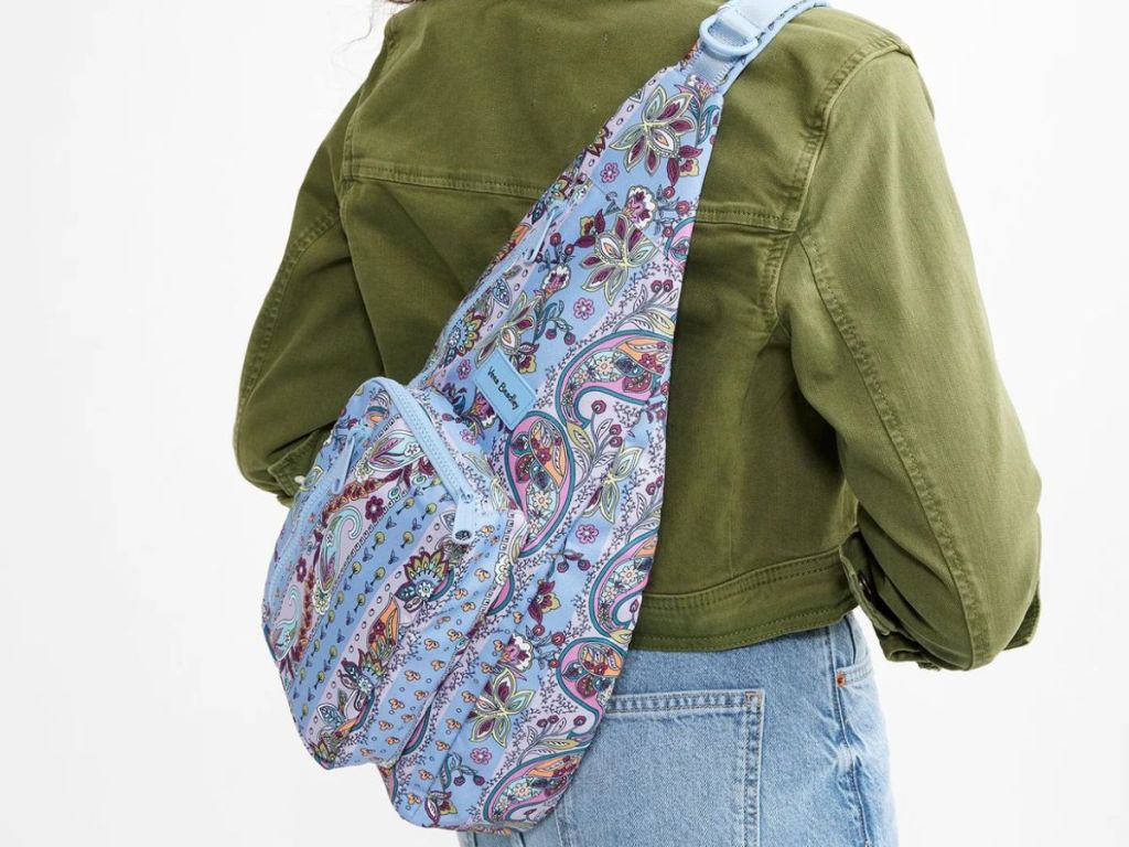 woman wearing a Vera Bradley ReActive Sling Backpack on her back