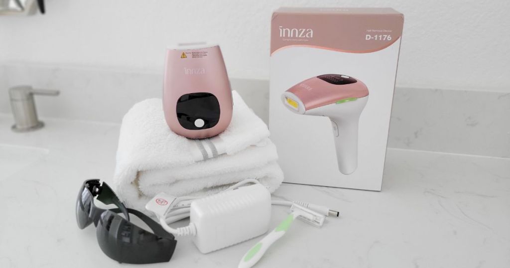 Innza hair remover towel, safety glasses, charger, and shaver on counter