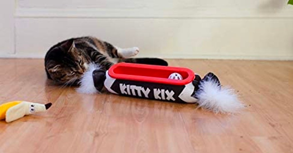 tabby cat playing with kitty kix cat toy