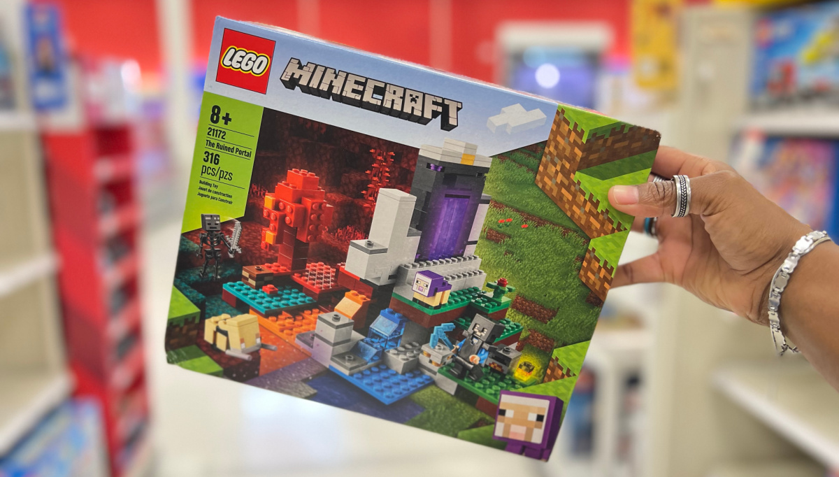 hand holding up lego minecraft sets in a target store aisle