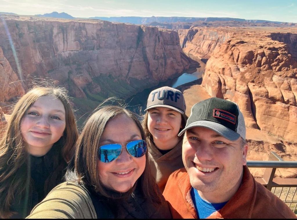 family posing outside in front of horseshoe bend