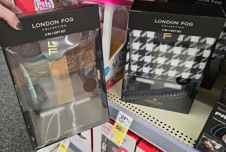 a womans hand holding a scarf wallet and charms gift set