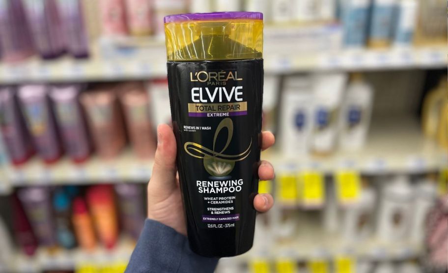 hand holding up elvive bottle in store