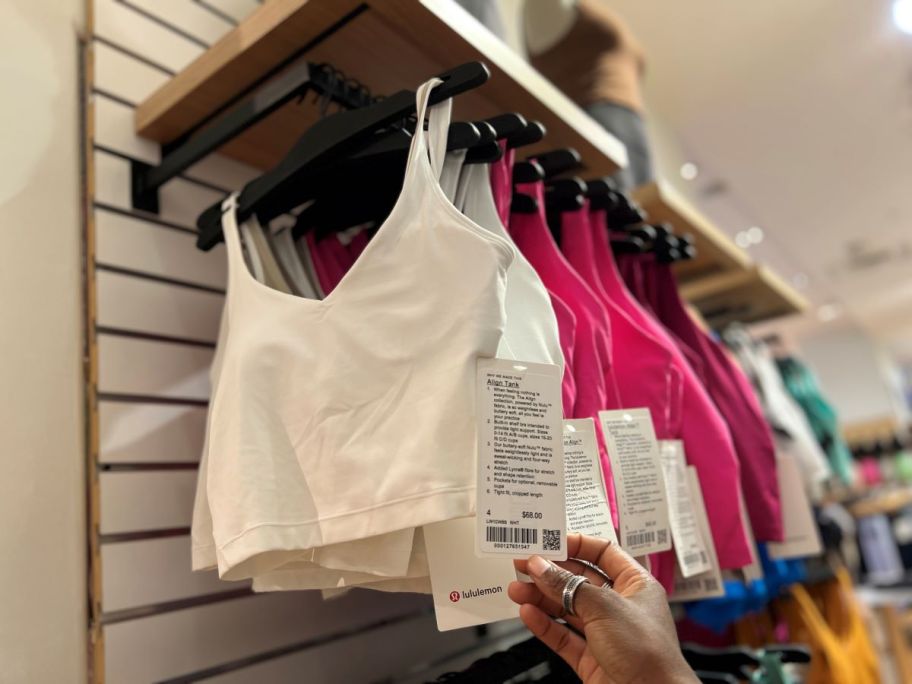 hand holding a tag on a lululemon tank top